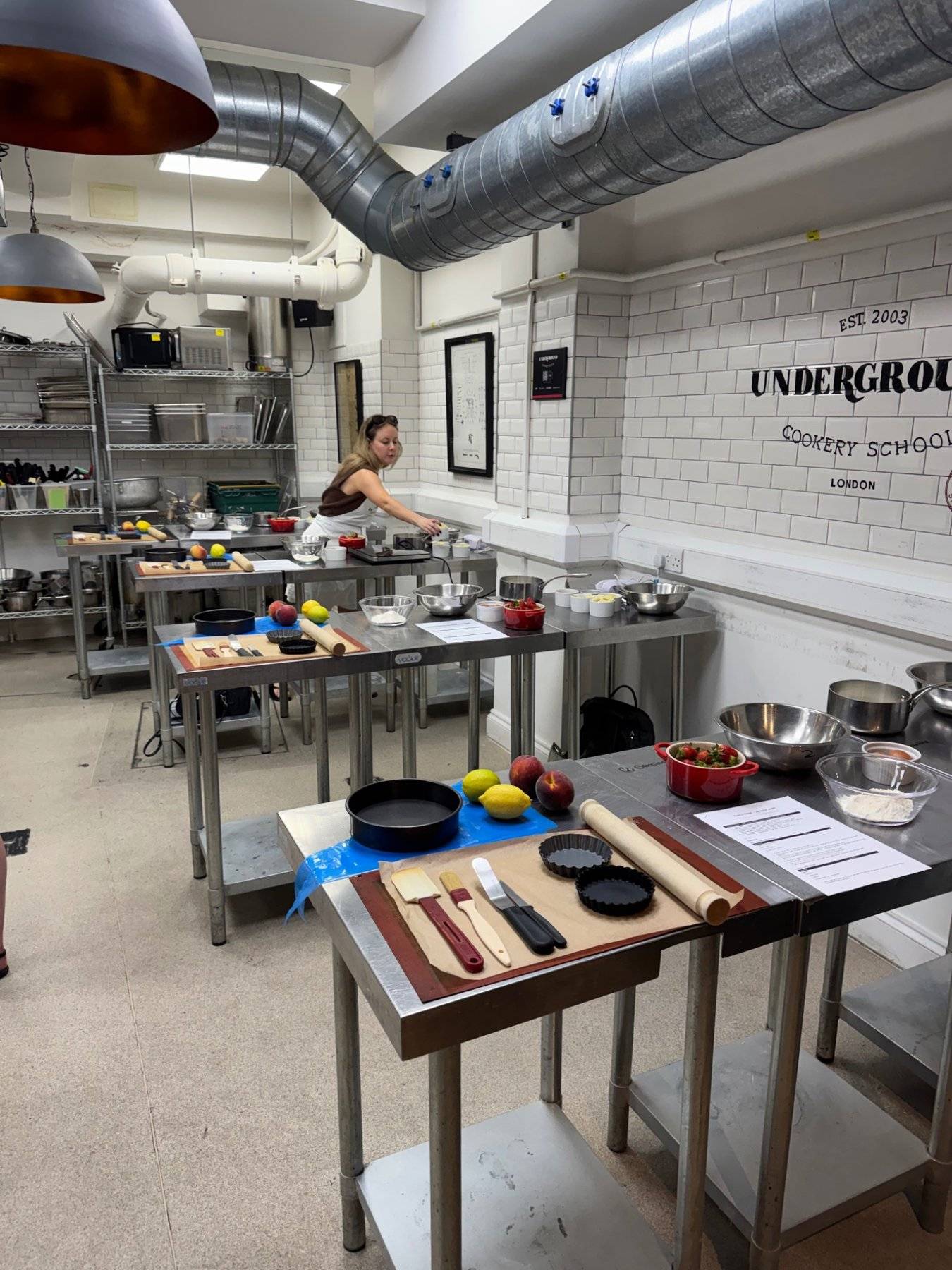 Active kitchen studio space with fresh produce, knives, and ingredients laid out for a commercial cooking production, Love Locations.