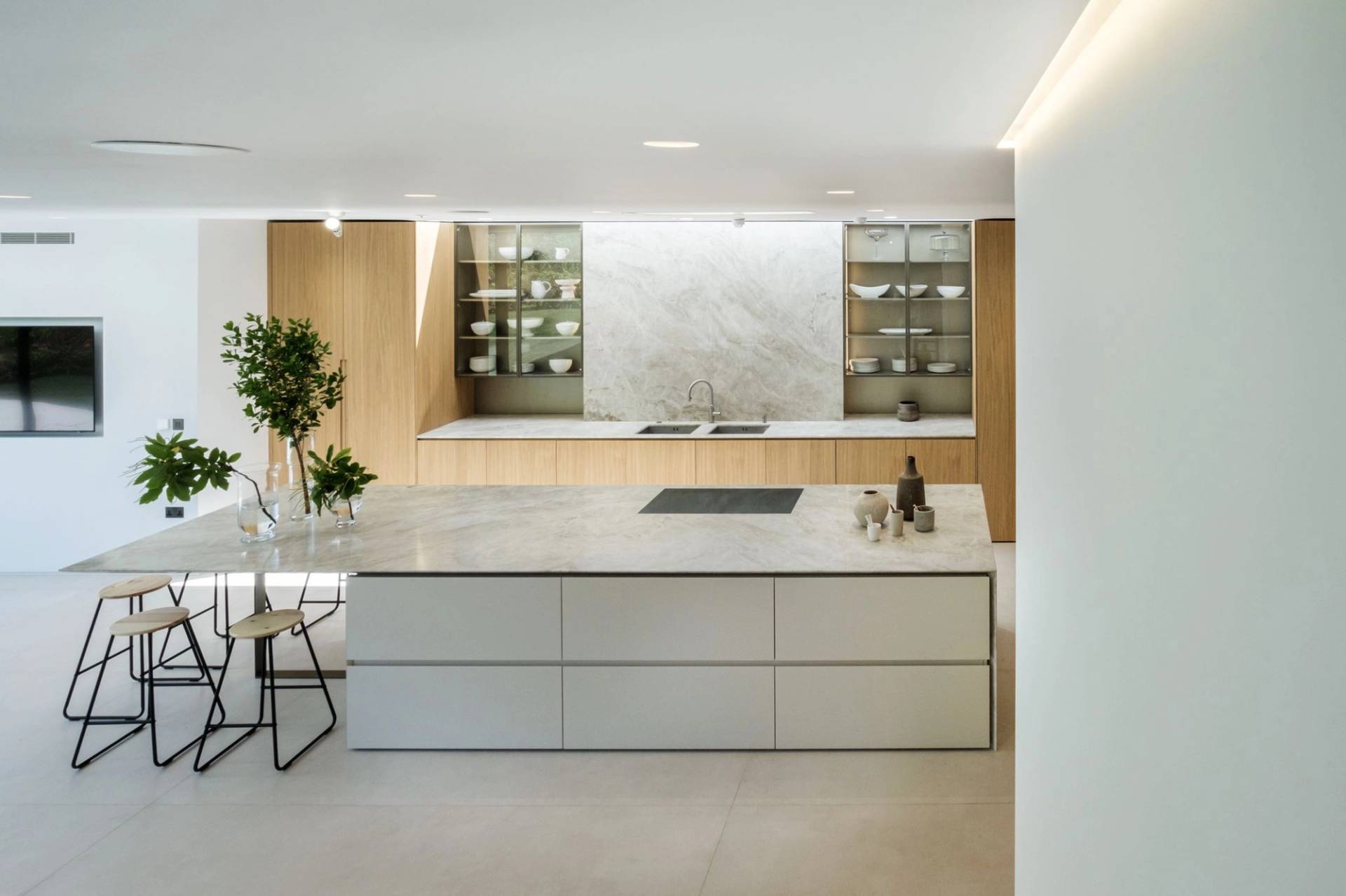 Sleek minimalist kitchen island with integrated induction hob and stone worktops in a modern North London location house, perfect for culinary product campaigns, Love Locations.