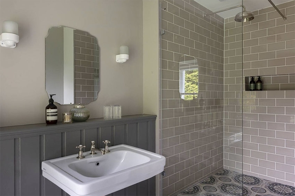 En-suite shower room with grey panelling and tiled walk-in shower