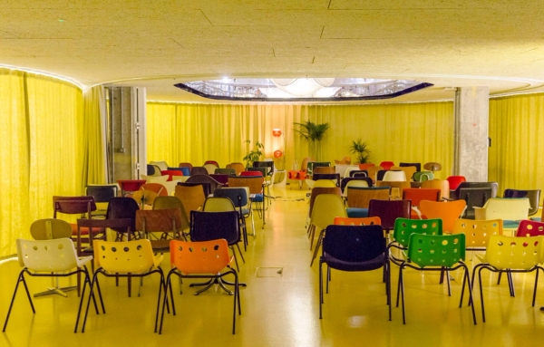Stylish East London event space with colourful chairs and presentation stage in Whitechapel E1 – love locations