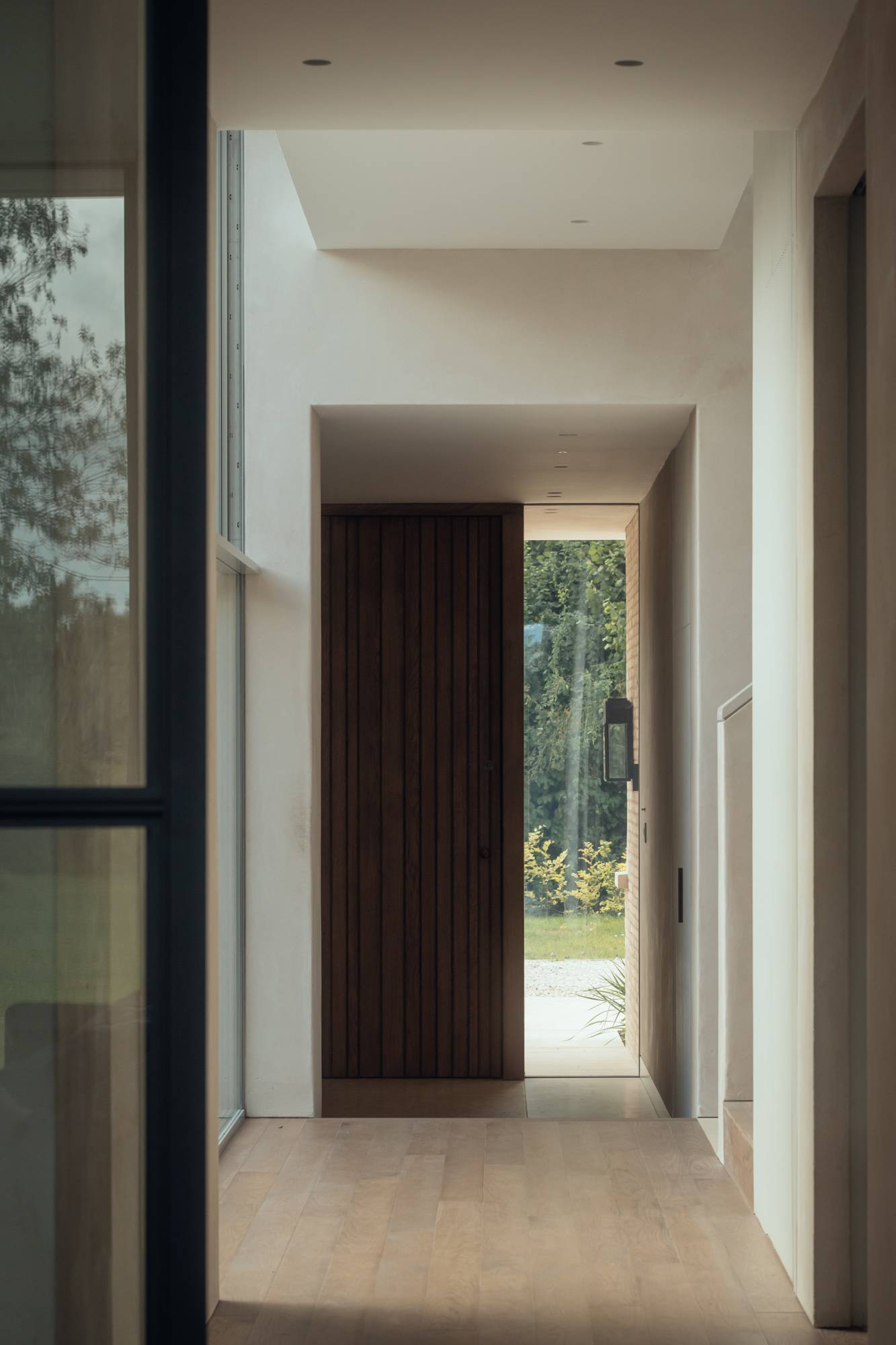 Seamless glass link corridor in a modern Stockbridge house looking through to a private inner courtyard, Love Locations SO20.