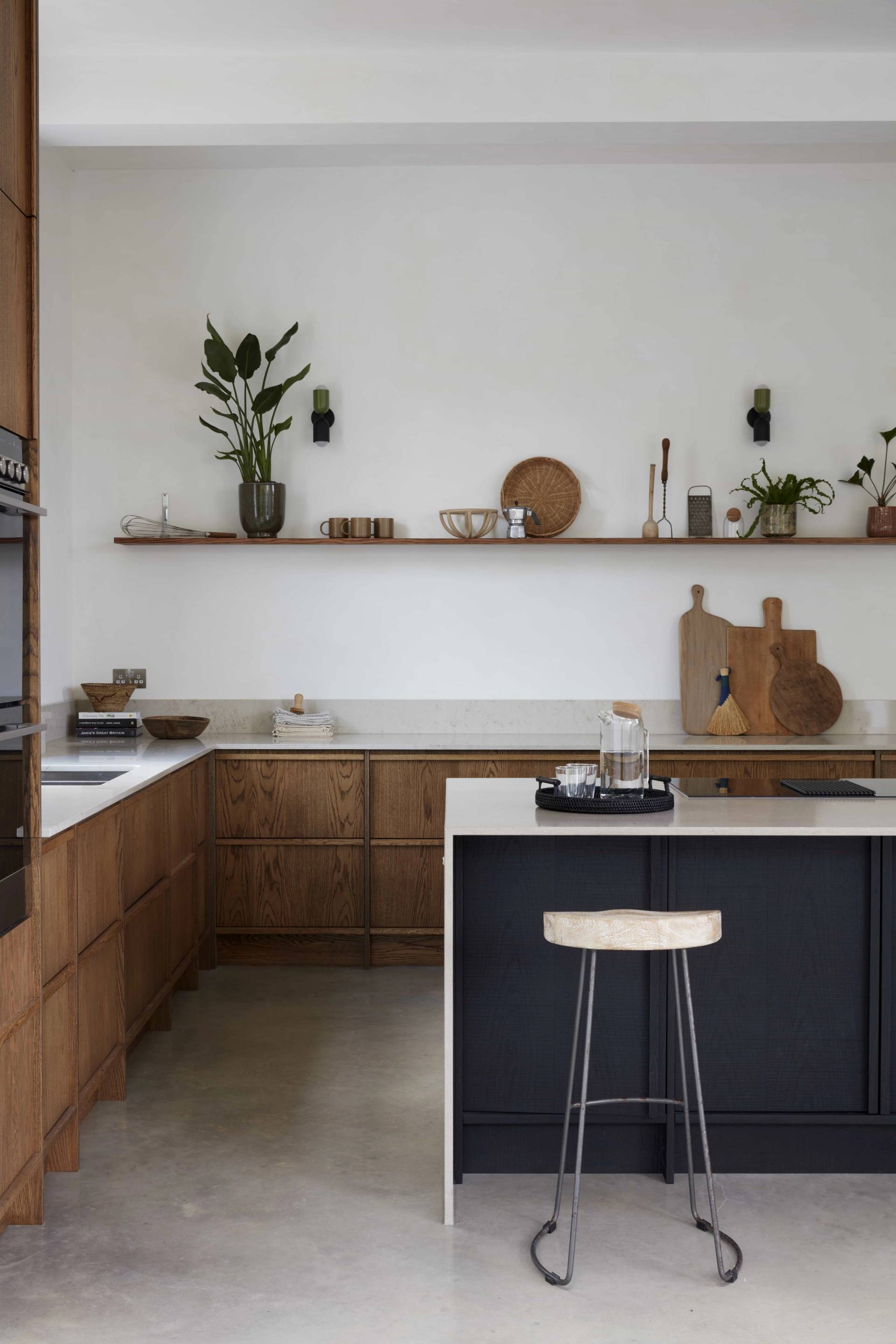 Sleek dark kitchen island and timber cabinetry set under exposed ceiling beams, ideal for home appliance marketing, Love Locations TN34.