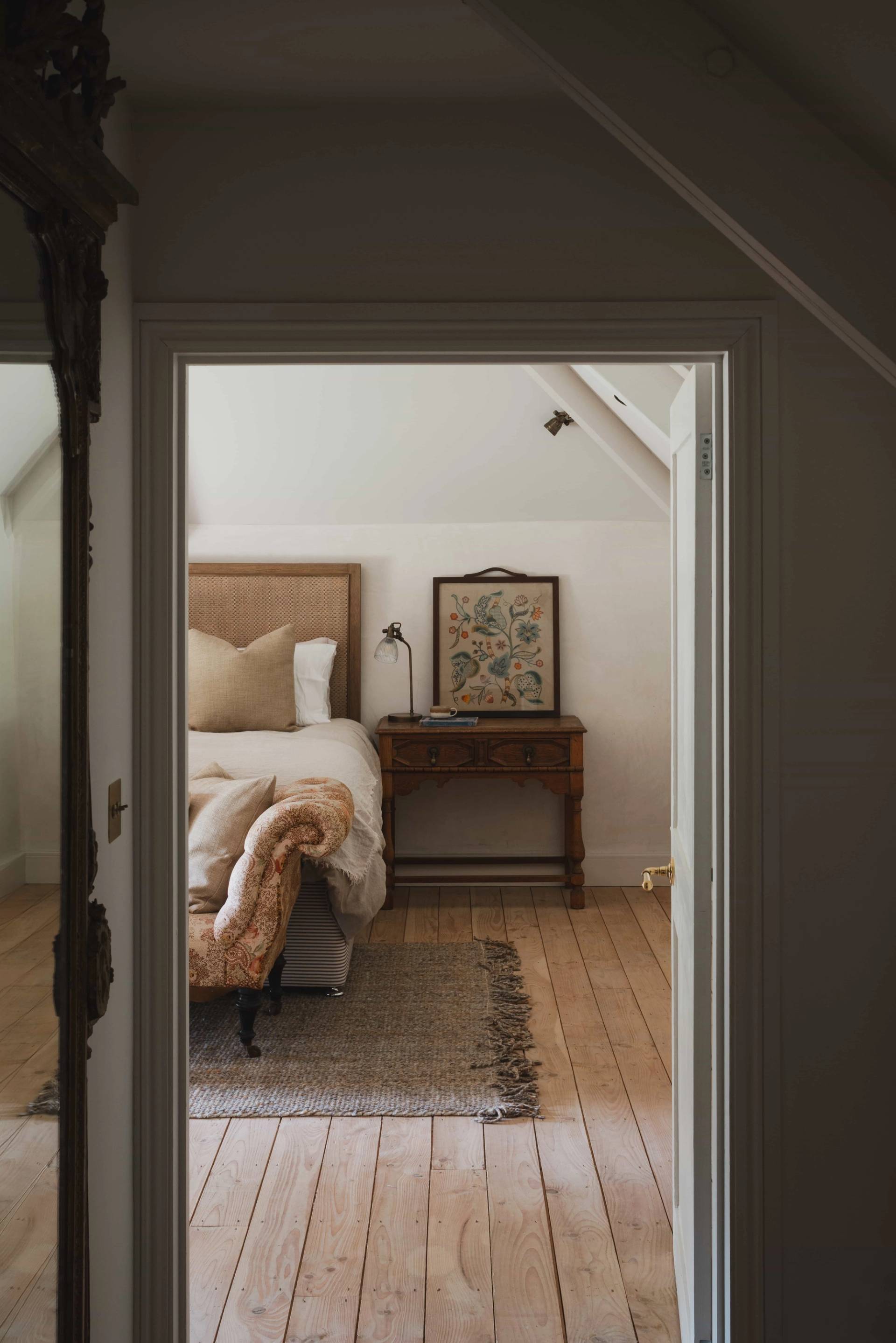 Doorway perspective into a neutral bedroom location house in a Grade II-listed Cornish manor via Love Locations.