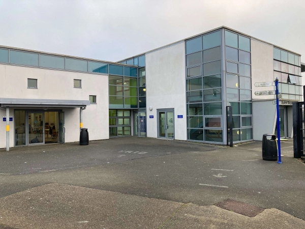 Love Locations contemporary school building exterior CM1: Striking modern architecture showcasing a multi-story white panel and glass curtain wall entrance facade, ideal for institutional establishing shots.