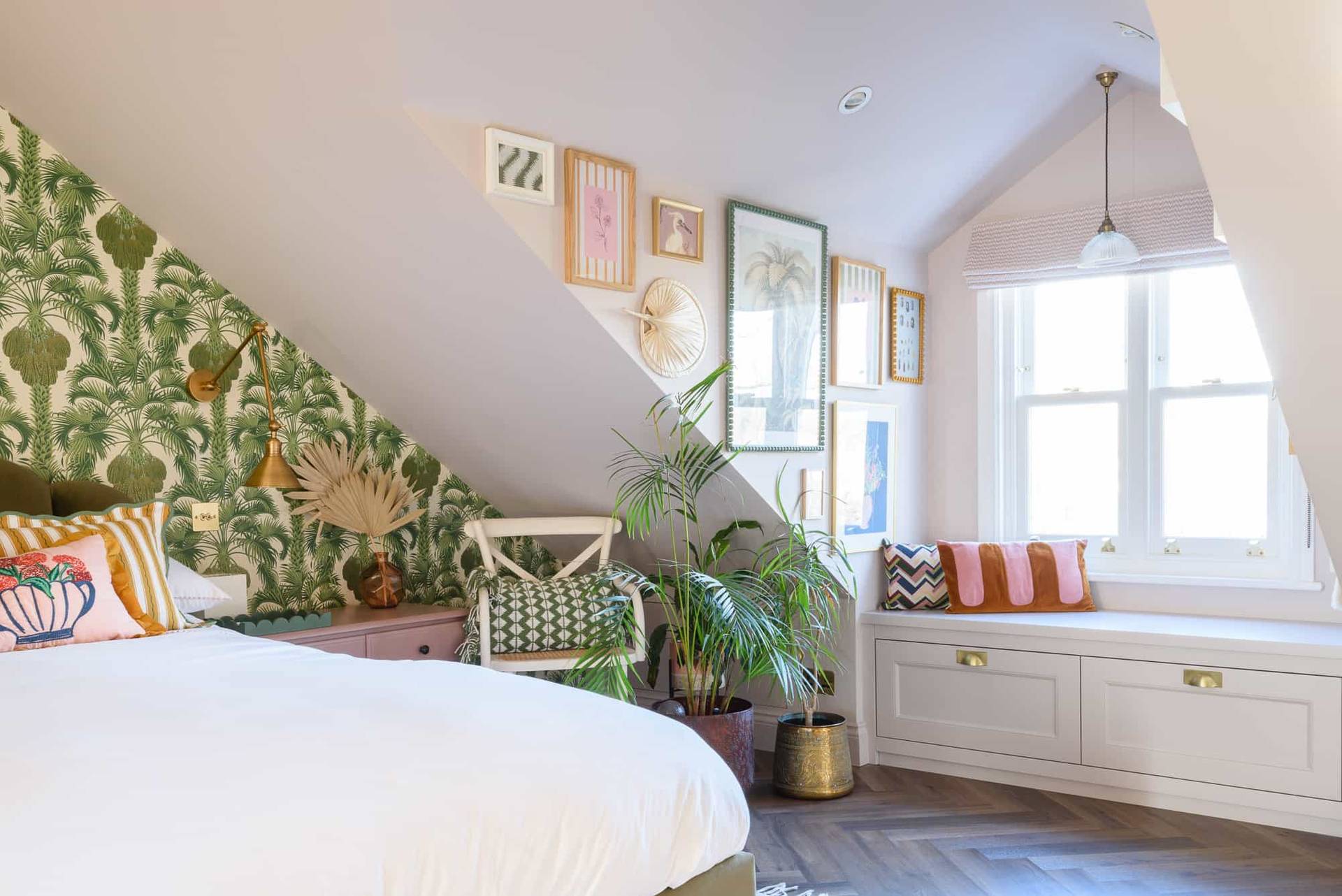 Attic bedroom reading corner with botanical wallpaper, woven armchair, and window light, Love Locations TW11.