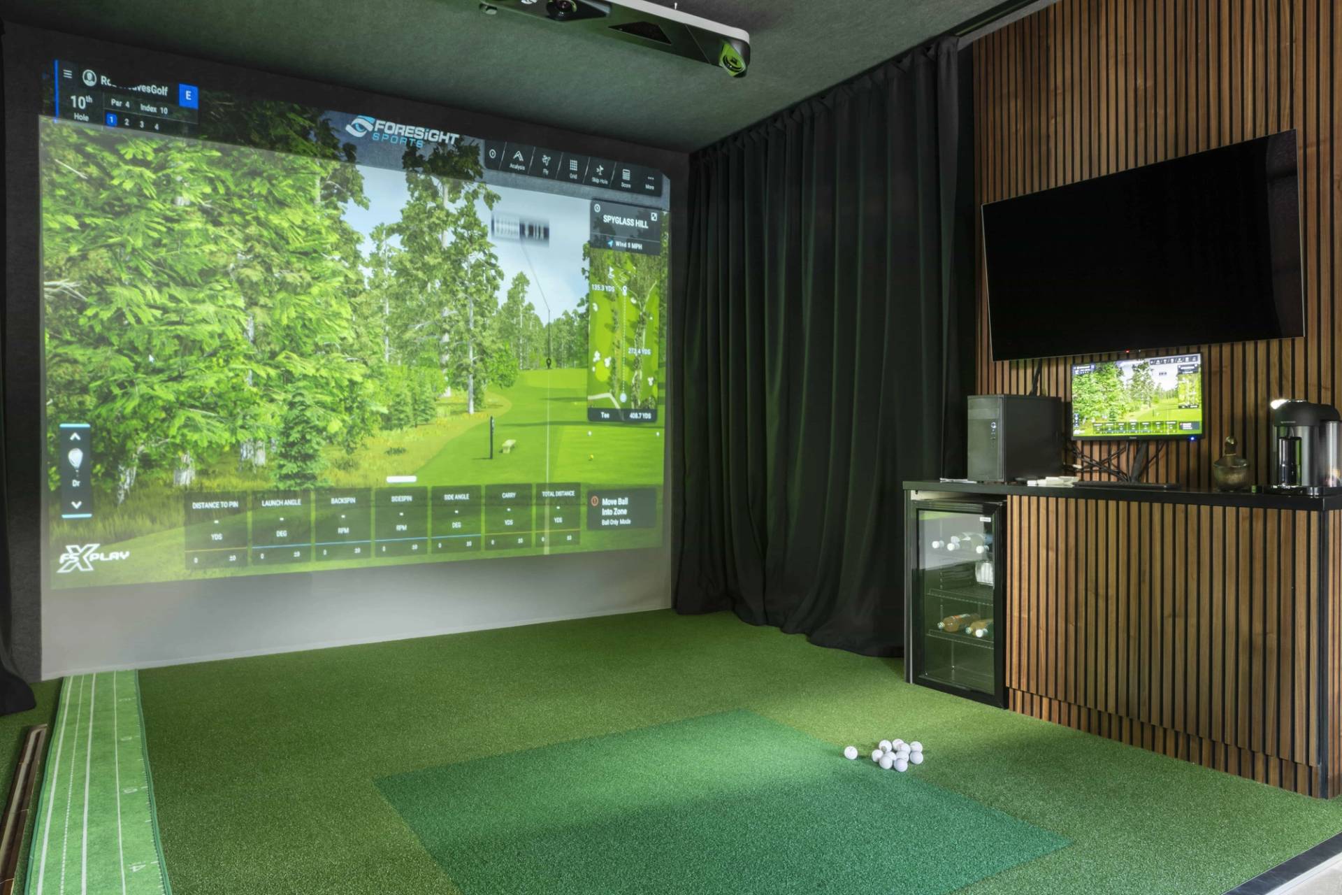 Private indoor golf simulator room set in a modern home entertainment suite, ideal for sports brand shoots, Love Locations HP18.