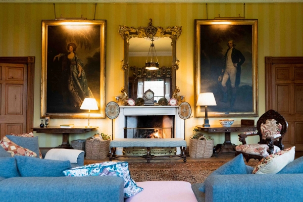 Formal castle living room with marble fireplace, large oil portraits, and gold framed mirrors, Love Locations KY15.