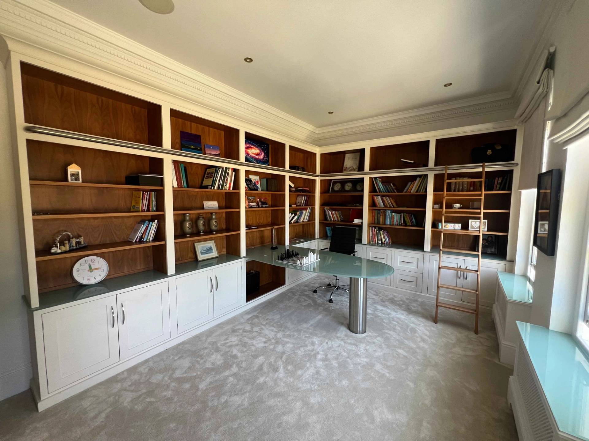 Mahogany panelled library study in Bromley, BR7 with floor-to-ceiling bookshelves and modern glass desk, Love Locations.