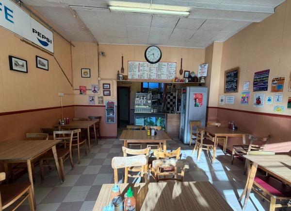 Full view of a traditional London greasy spoon diner dining room looking towards the service counter, Love Locations SE27.