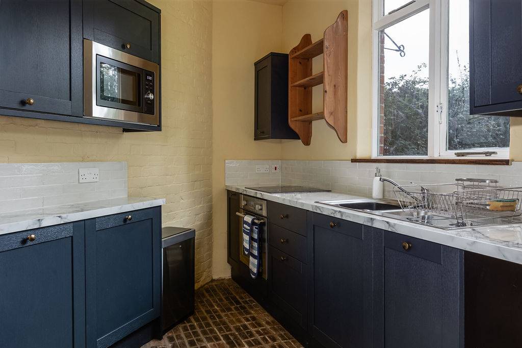 Compact contemporary kitchen with modern appliances at Love Locations house in Liss, Hampshire GU33.