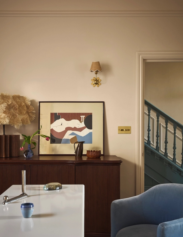 Hallway entrance perspective looking towards a dark wood sideboard, framed artwork, and staircase balustrade, Love Locations SE21.