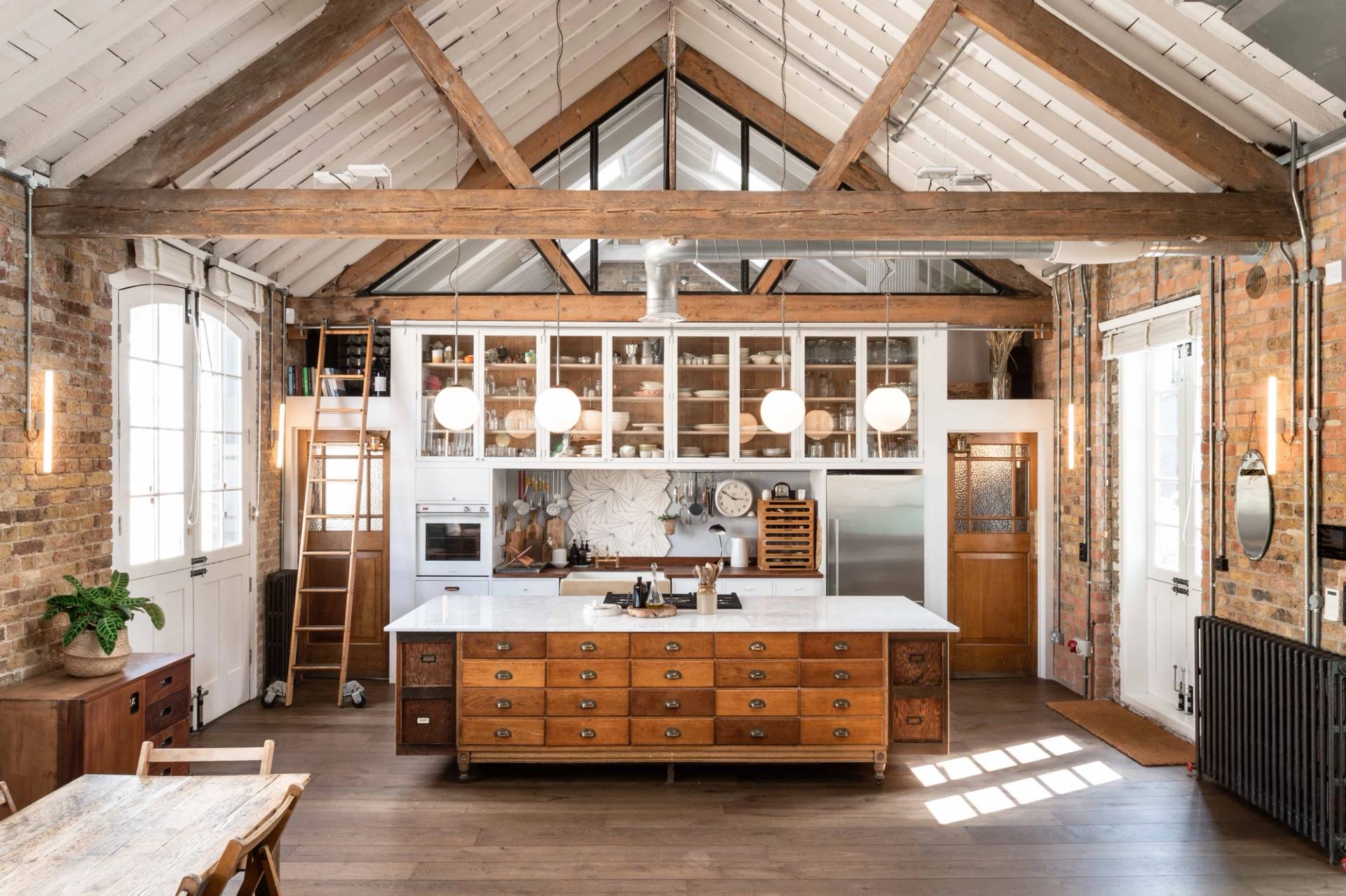 Industrial kitchen studio with exposed brick and island in Angel London N1 – love locations