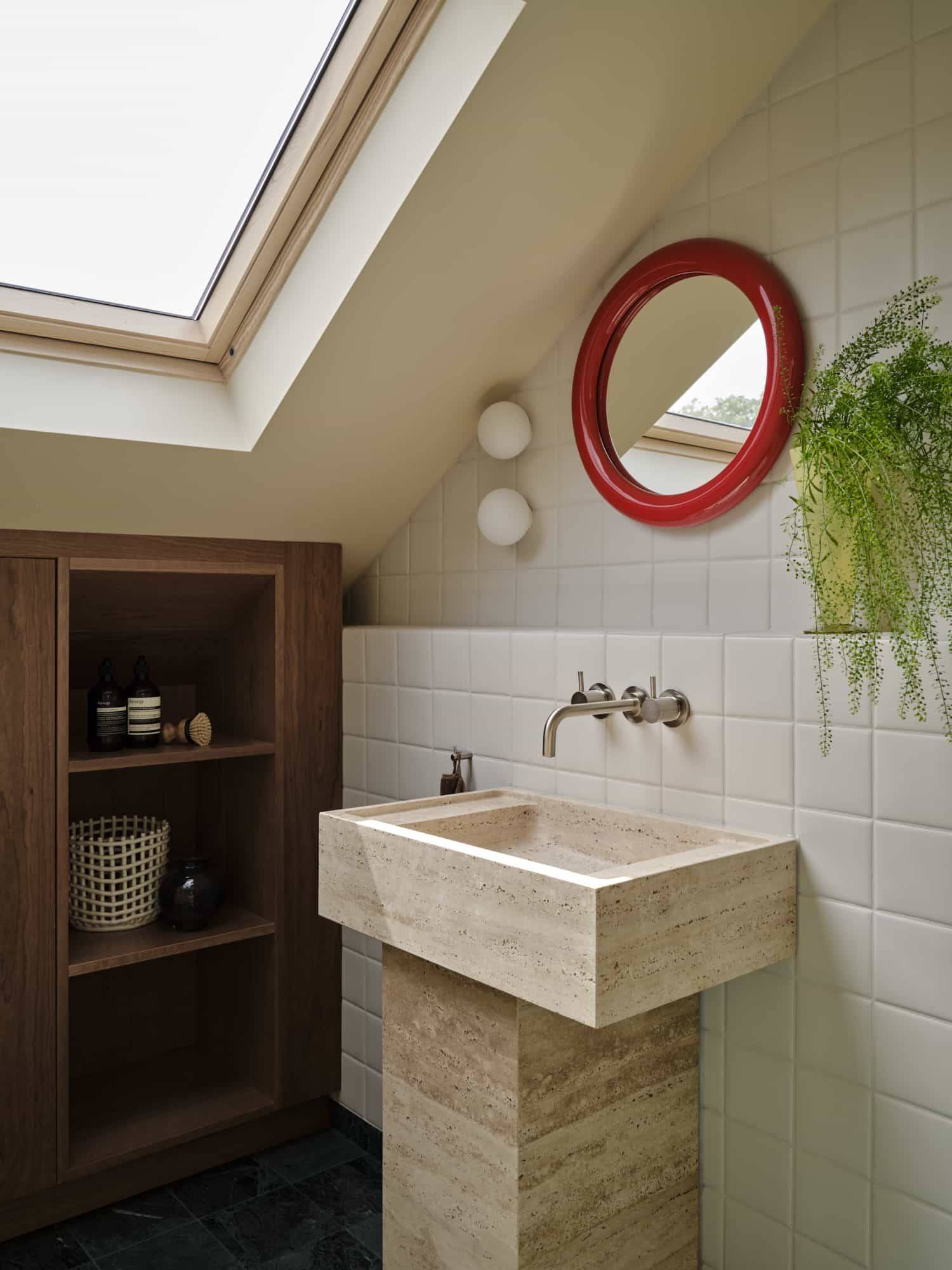 Love Locations high-end travertine bathroom SE23: Luxury washroom featuring a custom block travertine stone washstand under an open roof light, perfect for premium skincare commercials.