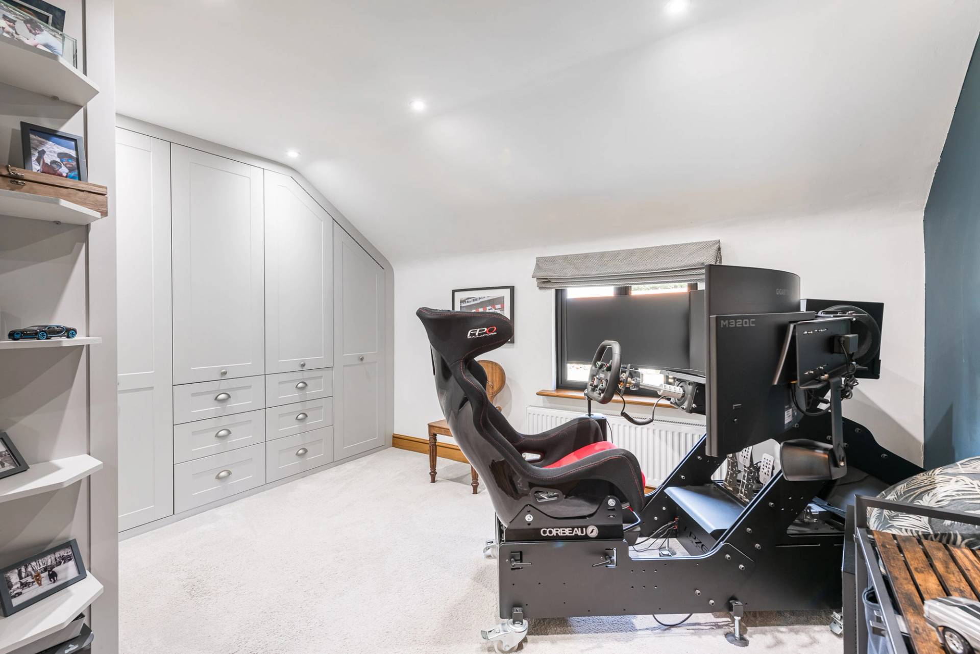 Unique home entertainment room location featuring a professional racing simulator setup and built-in storage, Love Locations.