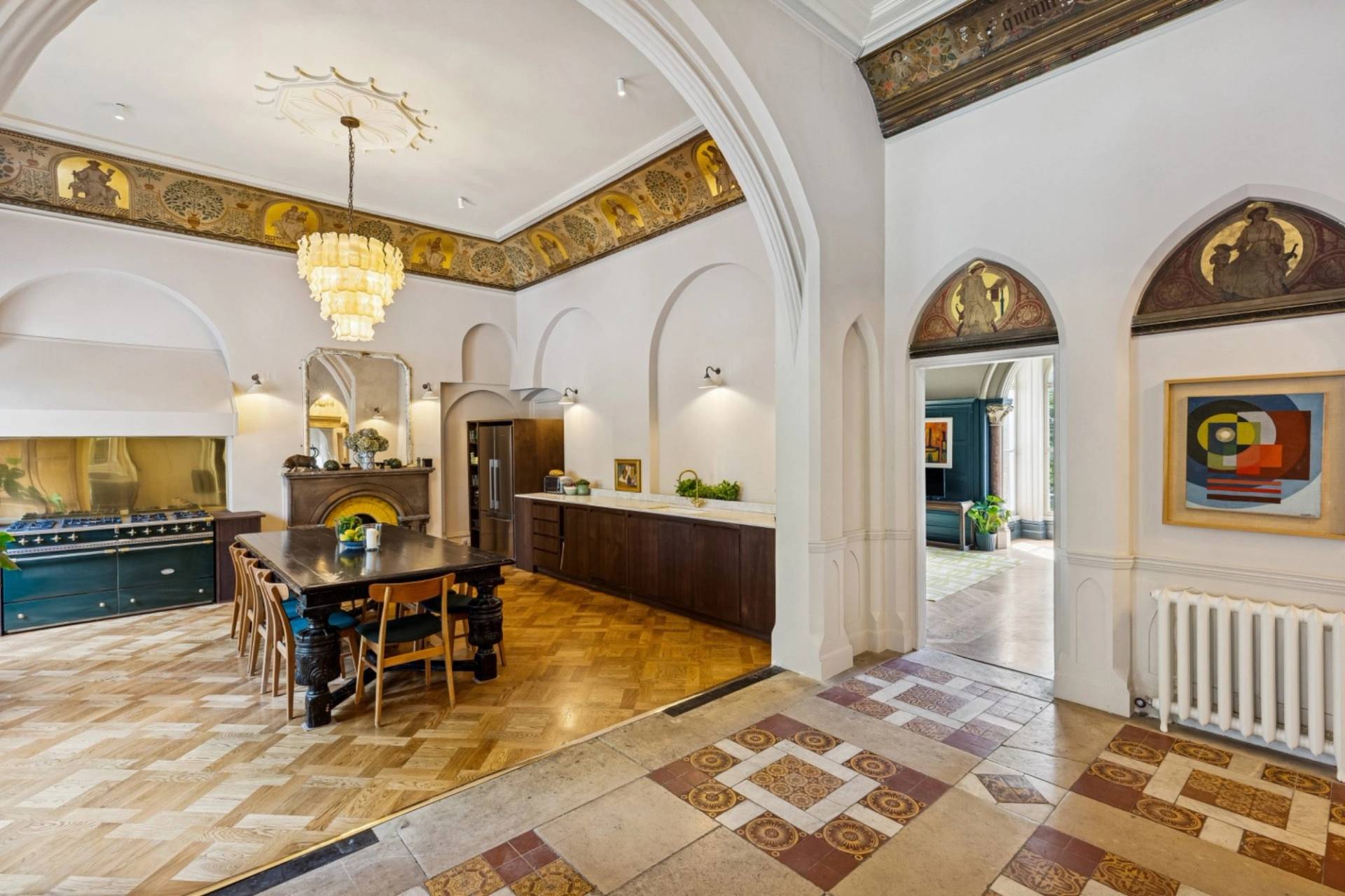 Open-plan transition between modern kitchen and grand dining room in a Hampstead gothic property from Love Locations.