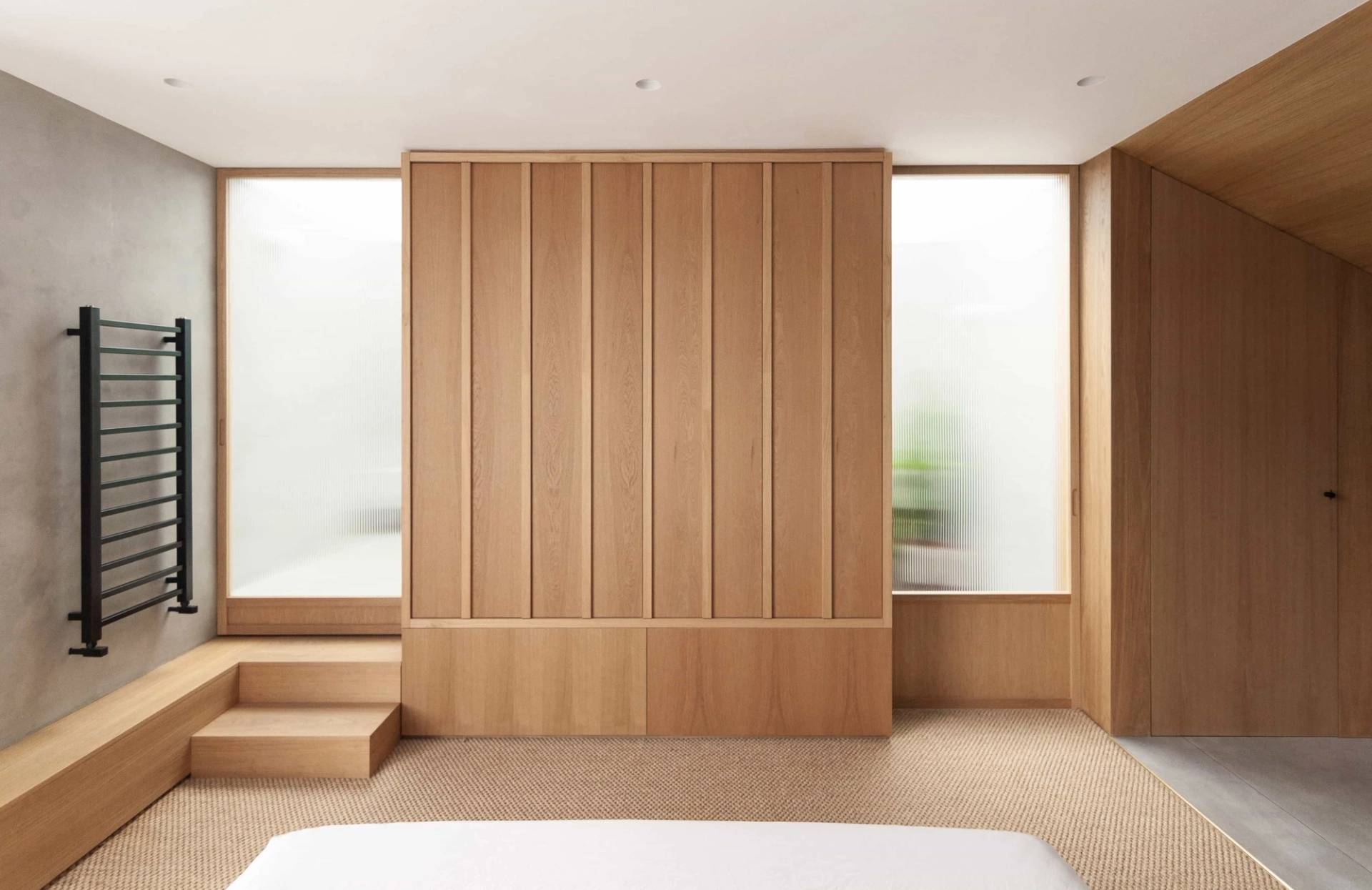 Japanese-inspired bedroom film location in Hackney N16 via Love Locations, showcasing light wood sliding screen doors and neutral linen bedding.