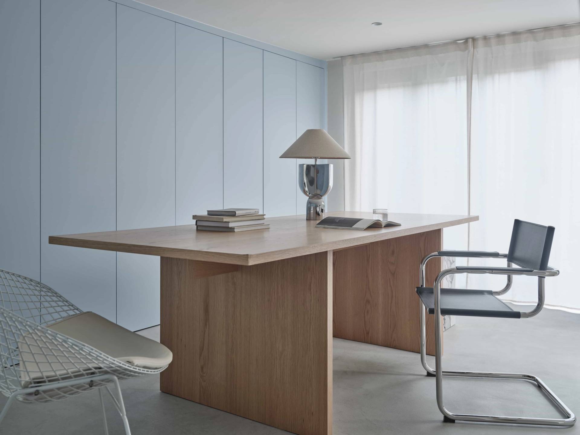 Light oak office desk set against powder blue wardrobe joinery in a black timber garden studio pod, Love Locations E4.