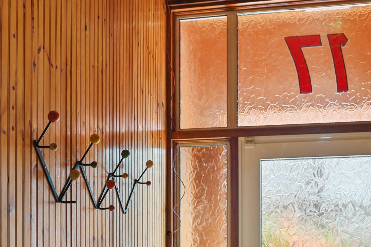 Textured amber glass door panel set in retro timber framing, Love Locations.