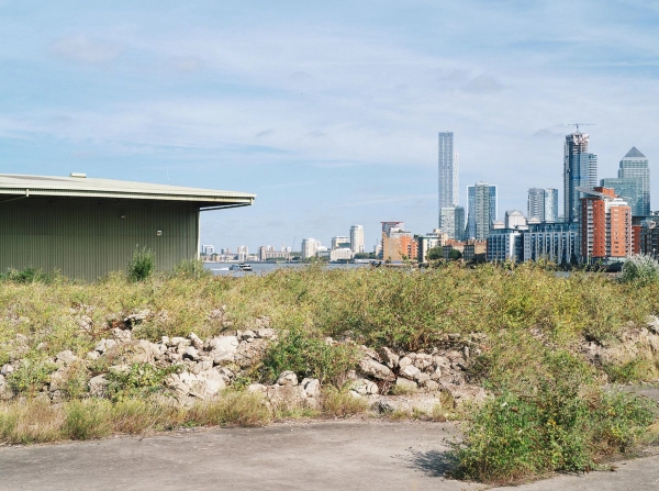 Riverside wasteland location plot in Deptford, SE8 overlooking the London Canary Wharf skyline, ideal for gritty urban outdoor shoots, managed by Love Locations.