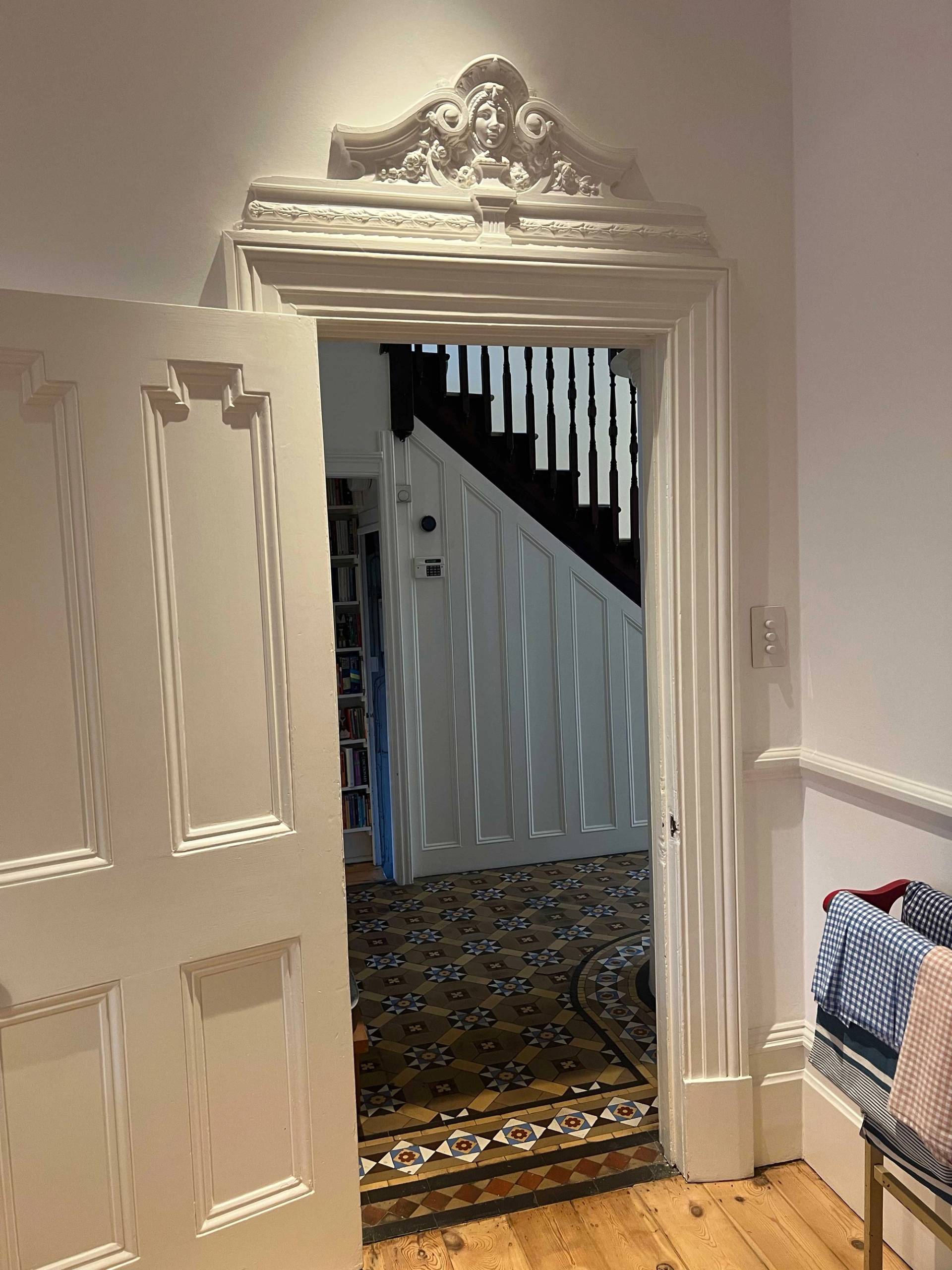 Grand Victorian entrance hall featuring white panelled doors and original tessellated mosaic floor tiles, Love Locations SE5.