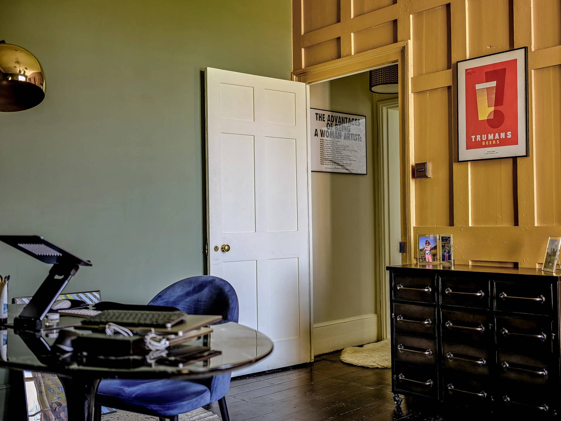 Olive green room view looking through open white double doors into an adjoining hallway, Love Locations.