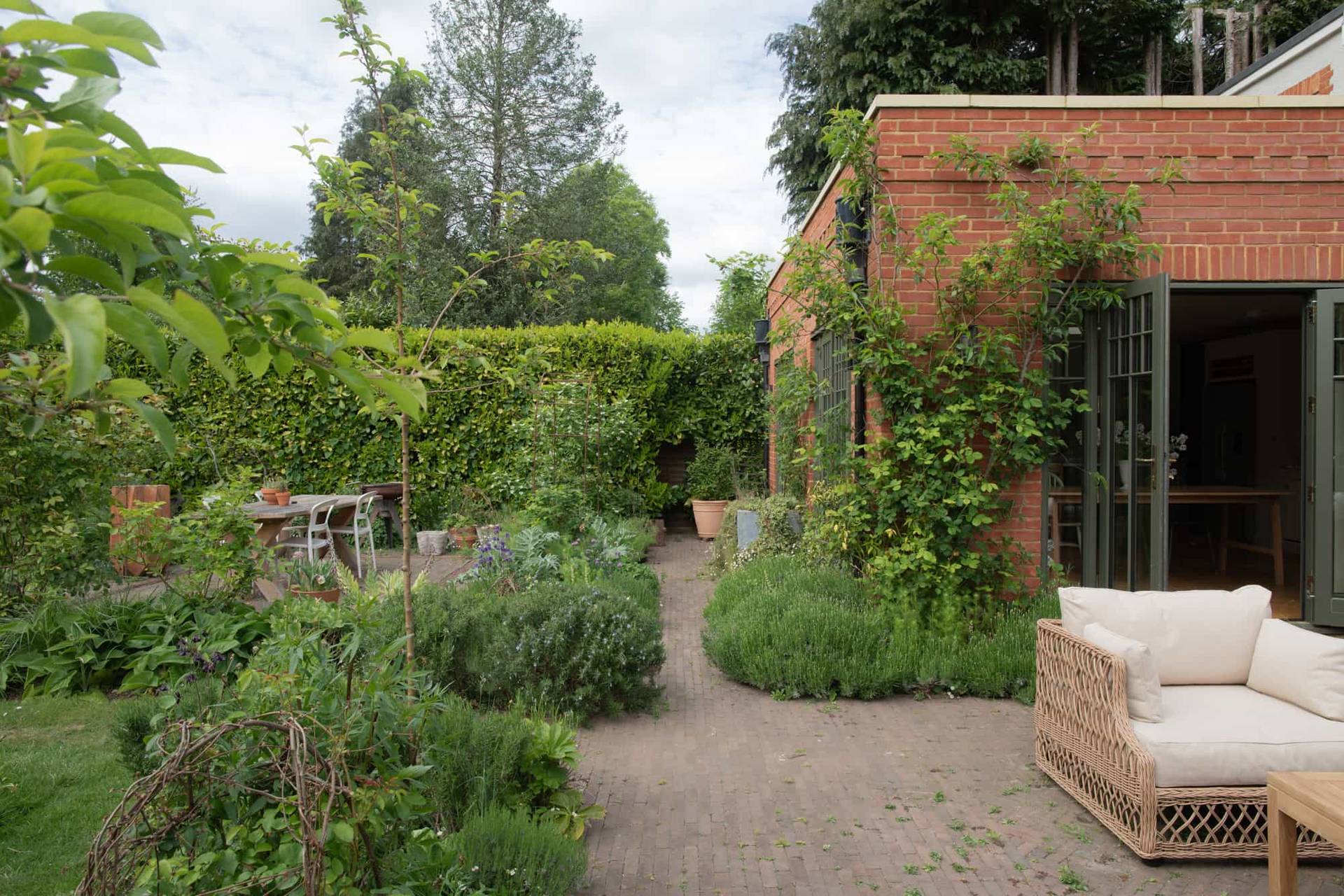 Stylish outdoor garden of a modern Surrey house in Horsley, showcasing natural light and greenery, Love Locations.