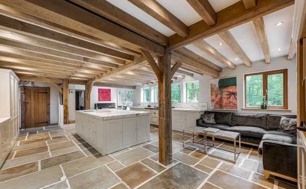 Stone-floored kitchen interior with wood beams in Essex, Love Locations
