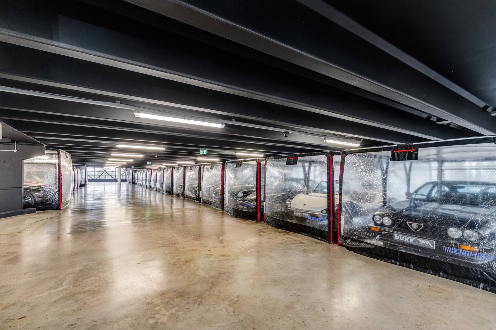 Perspective view down a long industrial car storage hall with polished concrete floors in Brentford TW8 from Love Locations.