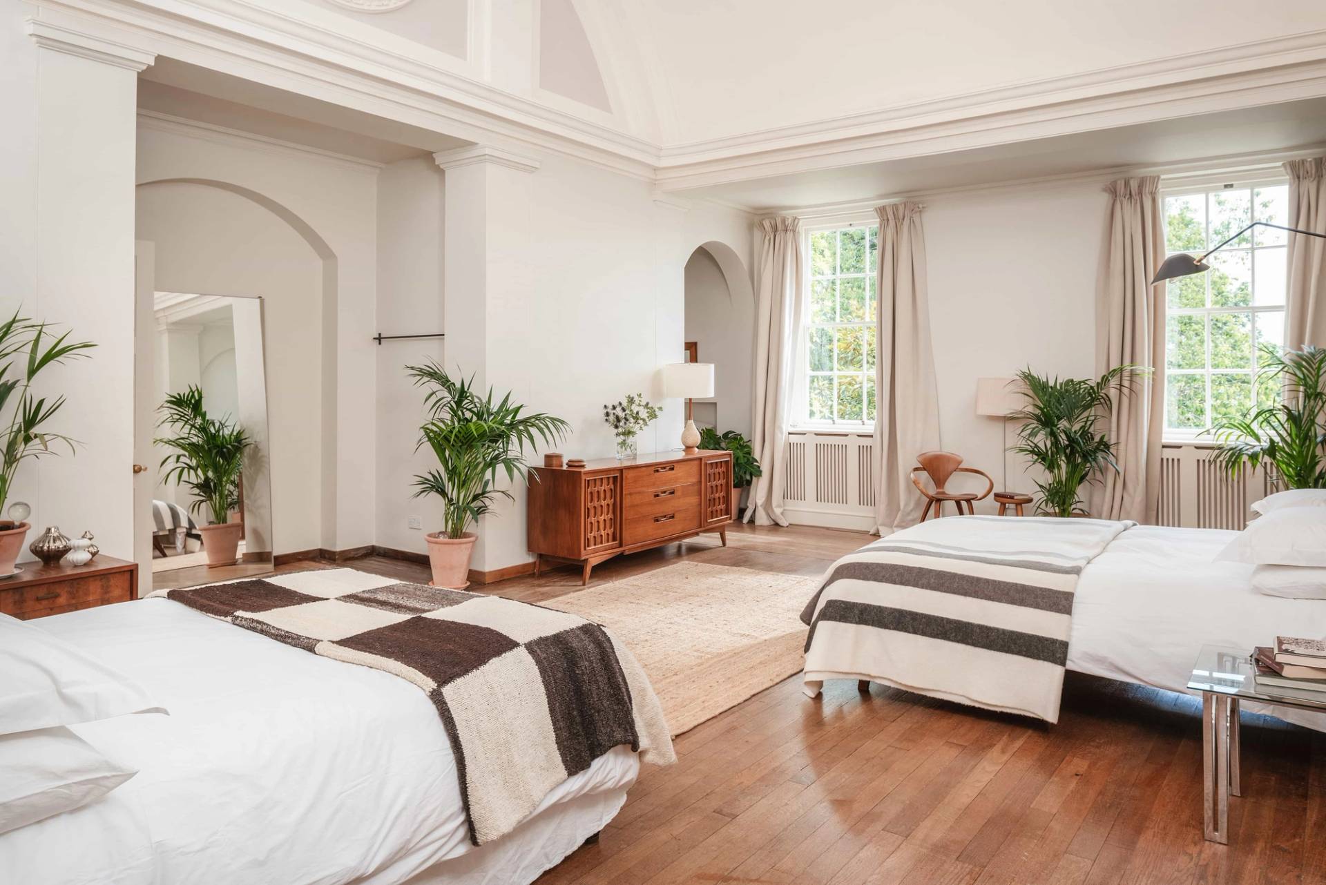 Luxury open-plan suite featuring vaulted ceilings, multiple beds, and a soft neutral palette in Totnes Devon TQ12 by Love Locations.