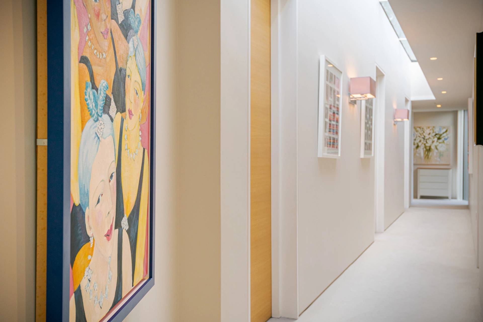 Modern hallway passage featuring vibrant abstract wall art prints and warm lighting, Love Locations KT2.