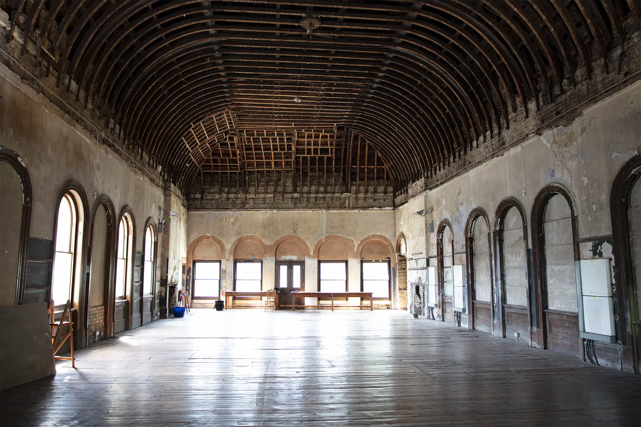 The Old Waiting Room at Peckham Rye — a Grade II listed Victorian ticket hall with vaulted timber ceiling, arched windows, and original patina.