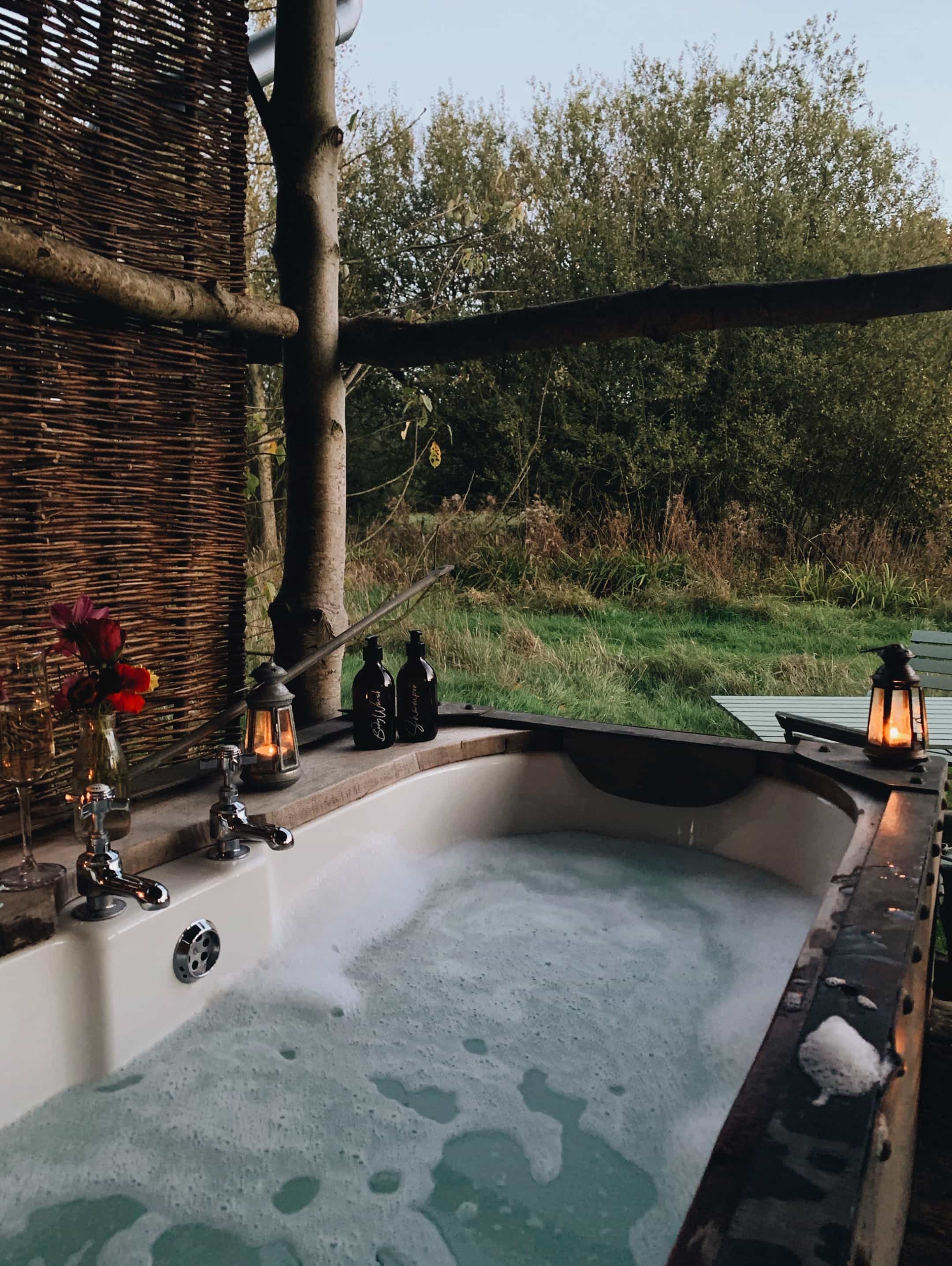 Outdoor bath with a view at Albion Cabin, Norfolk. Soak under the sky while looking out across open fields