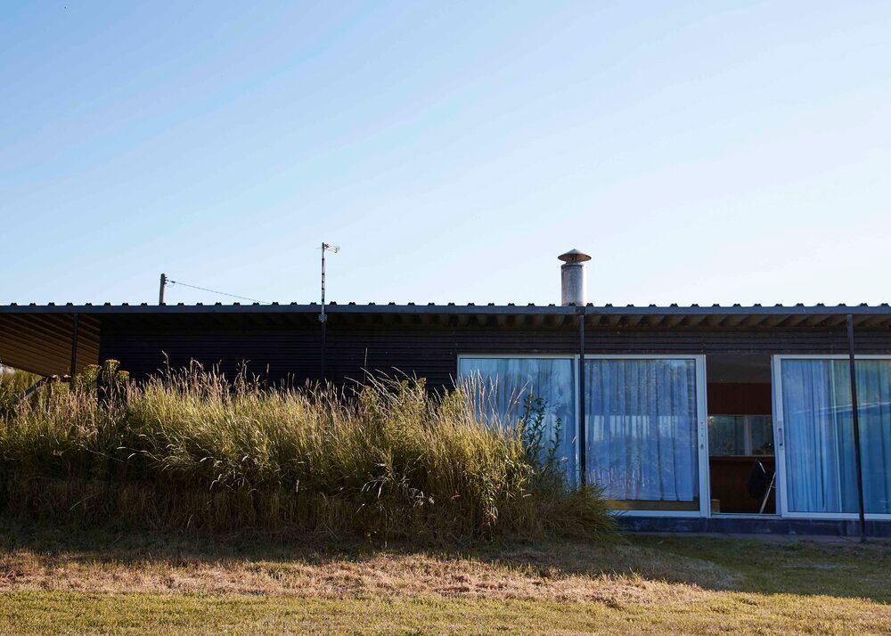 Exterior of Norfolk Beach House with black timber cladding, set on the Norfolk coast with beach access – ideal for contemporary seaside shoots.
