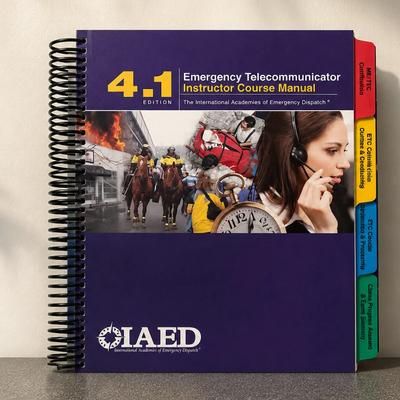 Spiral-bound course training manual with color-coded index tabs displayed on a tabletop.