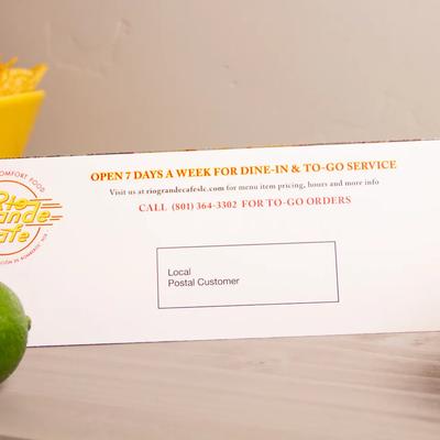 Addressed direct mail brochure prepared for mailing and fulfillment with printed postage and recipient information.