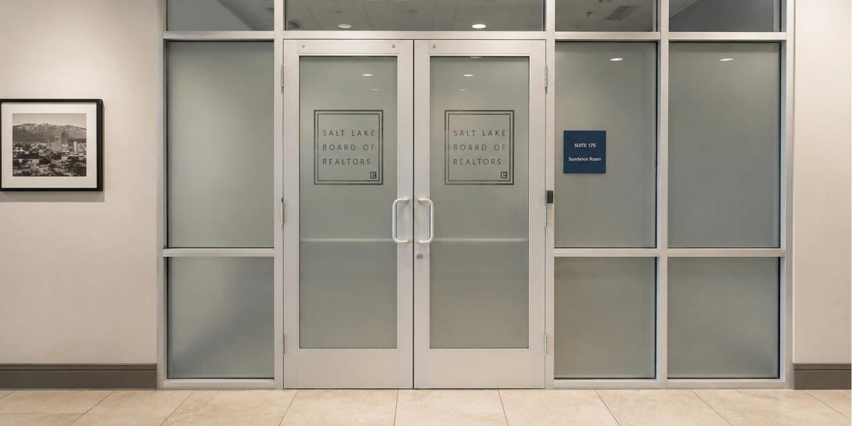 Office windows and glass doors with decorative frosted vinyl installed onto them.