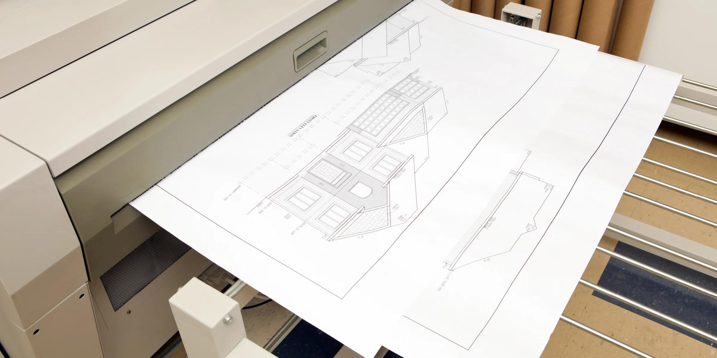 Large-format scanner digitizing oversized architectural blueprints and engineering drawings.