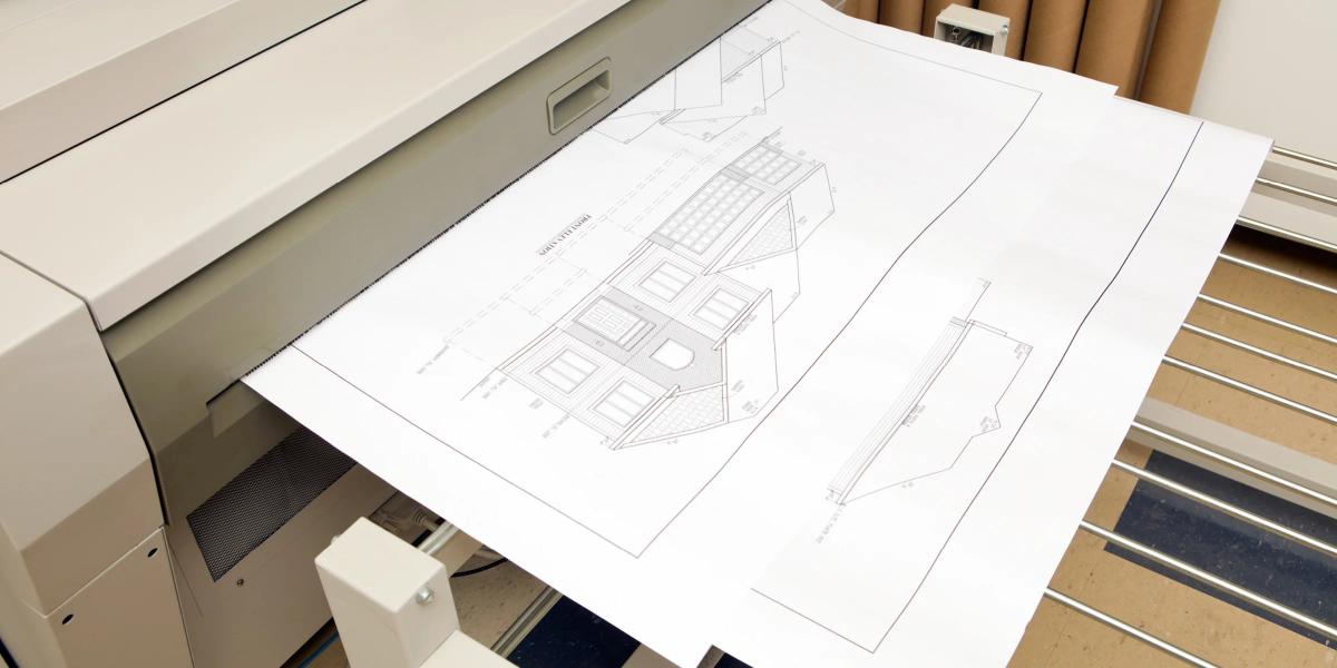 Large-format scanner digitizing oversized architectural blueprints and engineering drawings.