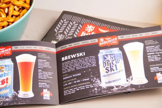 Open booklet spread for "Brewski," a German Pilsner listed at 4.2% ABV, 30 IBU, straw color, with a can and poured glass alongside notable comparable beers.