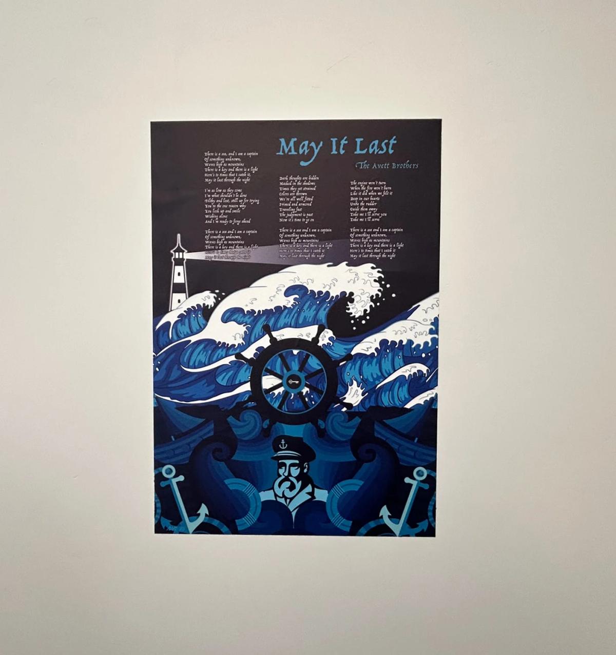 Decorative textile wall graphic featuring illustrated artwork and typography displayed on an interior wall.