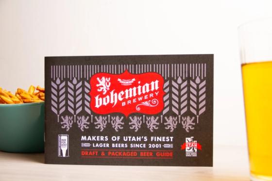 Bohemian Brewery beer guide cover showing the red crest logo, wheat and heraldic lion pattern, and the Proudly Made in Utah independent brewer seal.