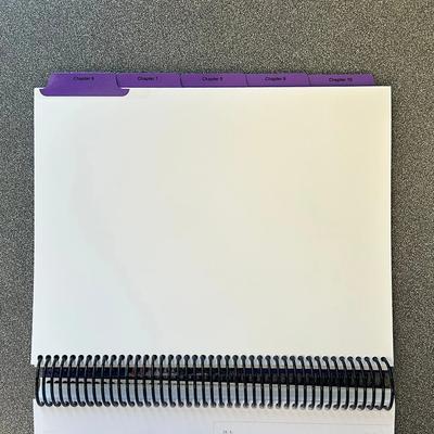 Spiral-bound presentation booklet with custom printed index tabs for organized document navigation.