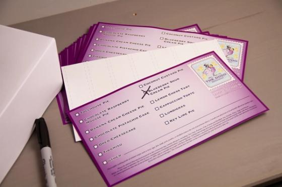 Dodo dessert labels with a white liner sheet laid across them, showing the die-cut lines the labels peel from.
