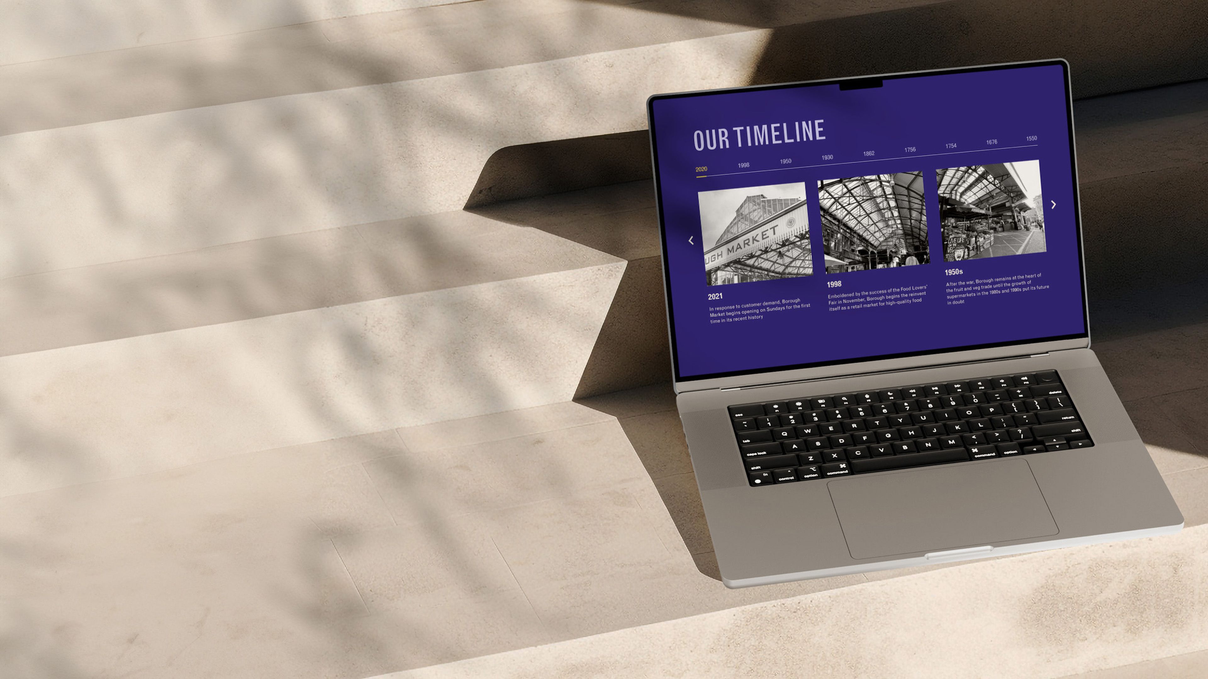 Borough Market website on a laptop, showing the "Our timeline" section with archive photos of the market