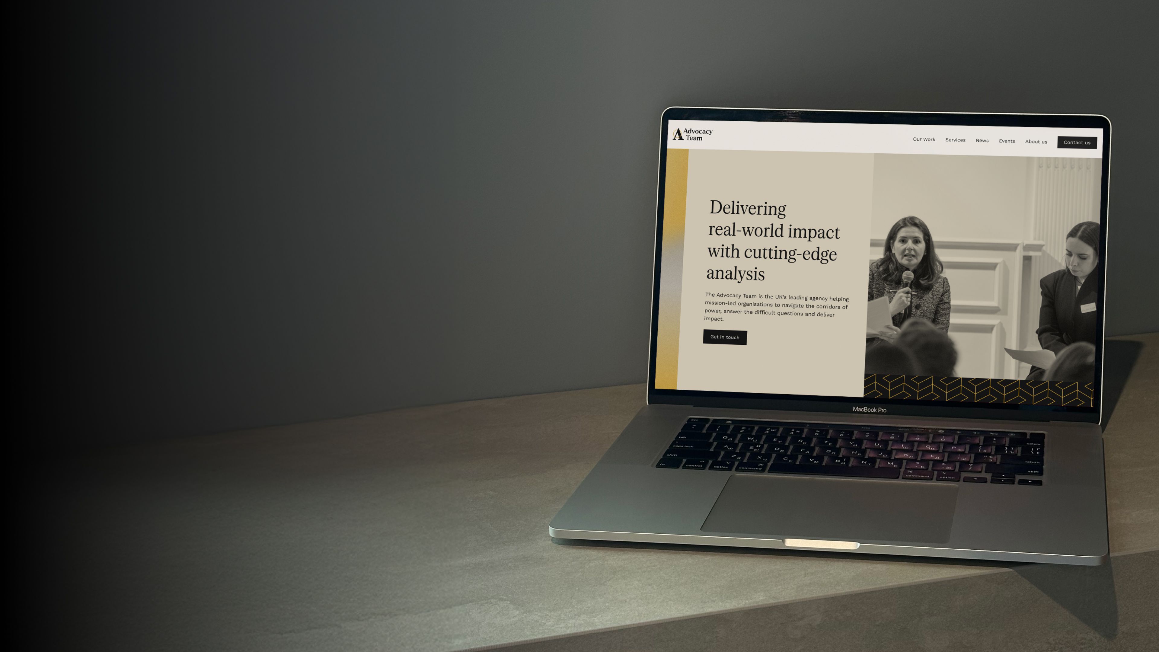 The Advocacy Team homepage on a laptop, headlined "Delivering real-world impact with cutting-edge analysis"