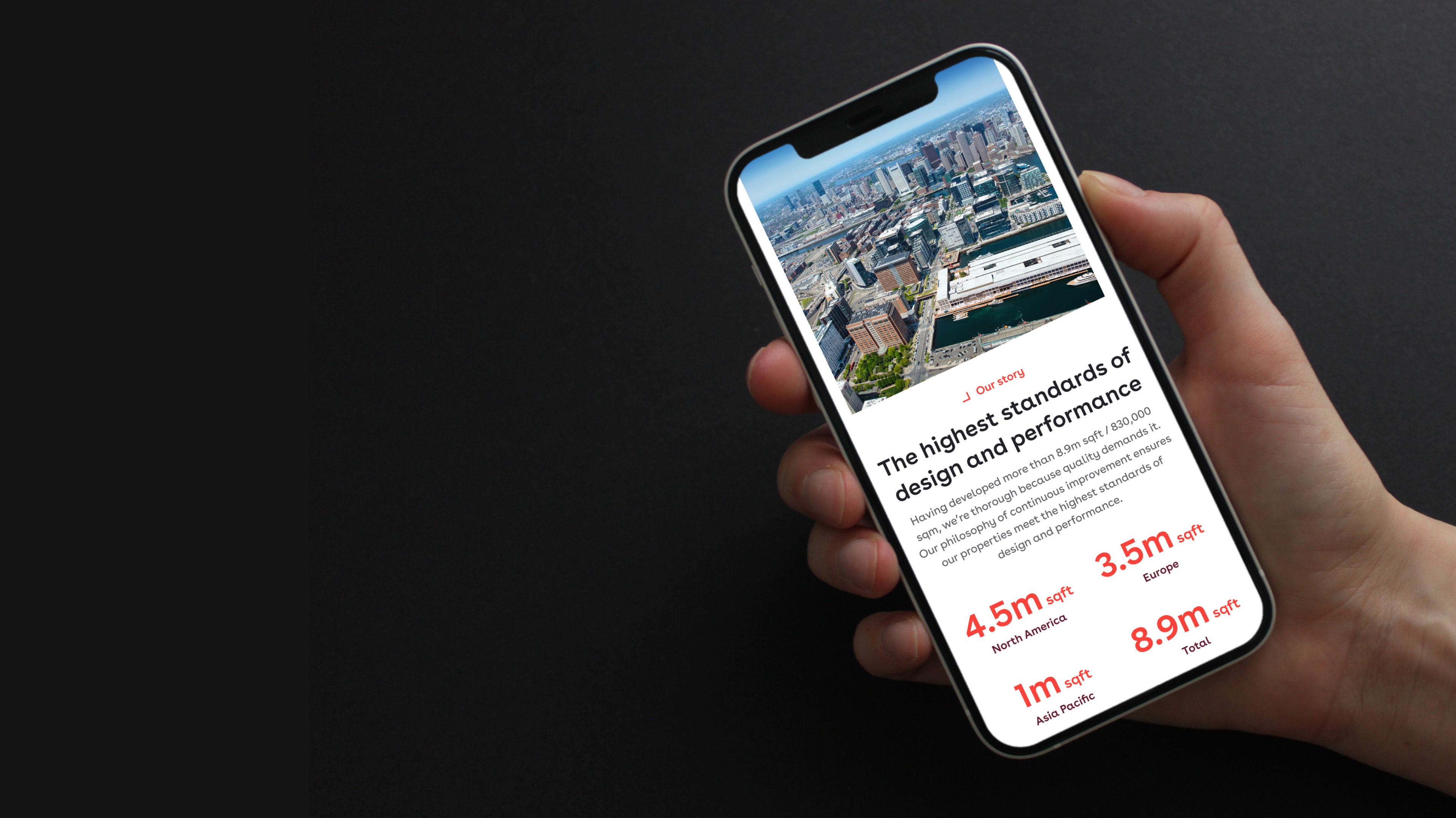 Pembroke website on a phone, showing an aerial city view and floor space figures, including "8.9m sqft" in total