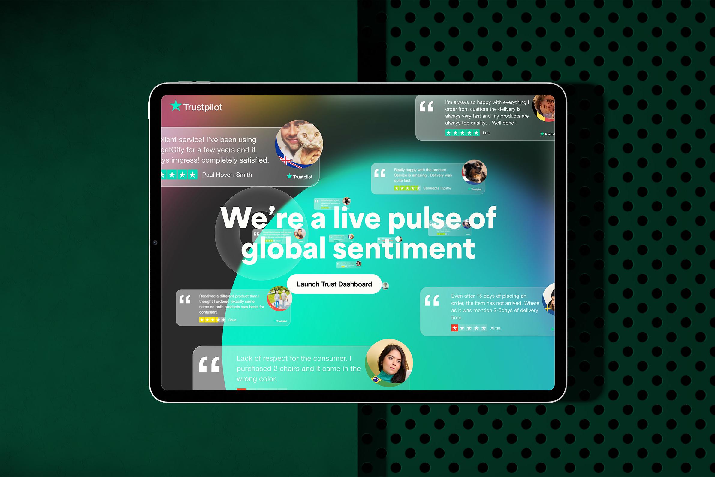 Trustpilot interactive experience on a tablet, with floating reviews around the headline "We're a live pulse of global sentiment"