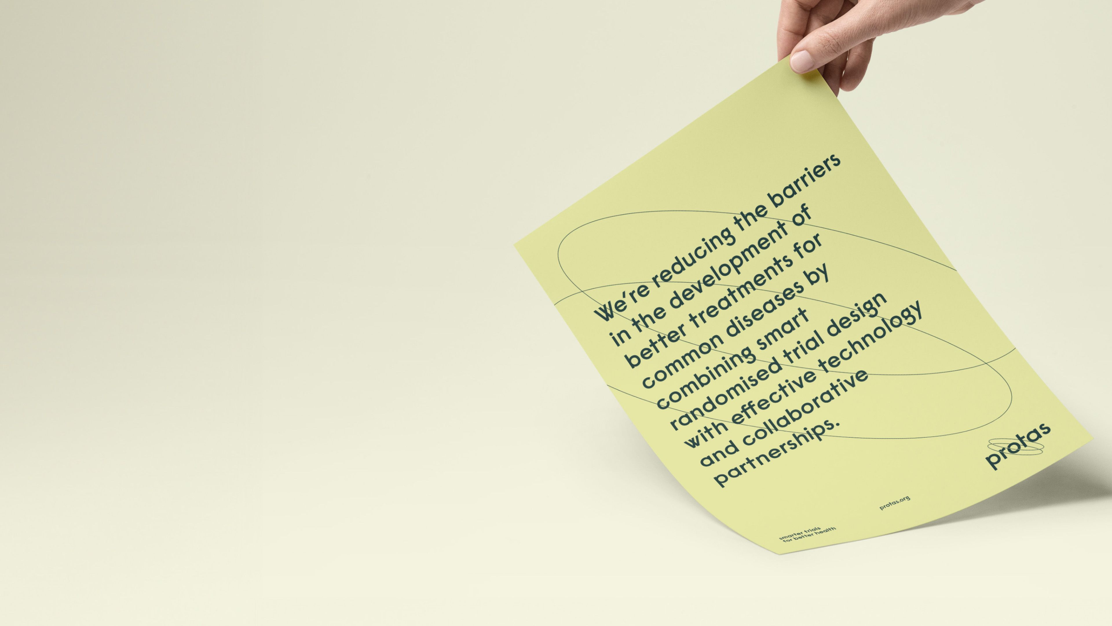 Protas leaflet held in a hand, setting out its mission to reduce barriers to better treatments for common diseases