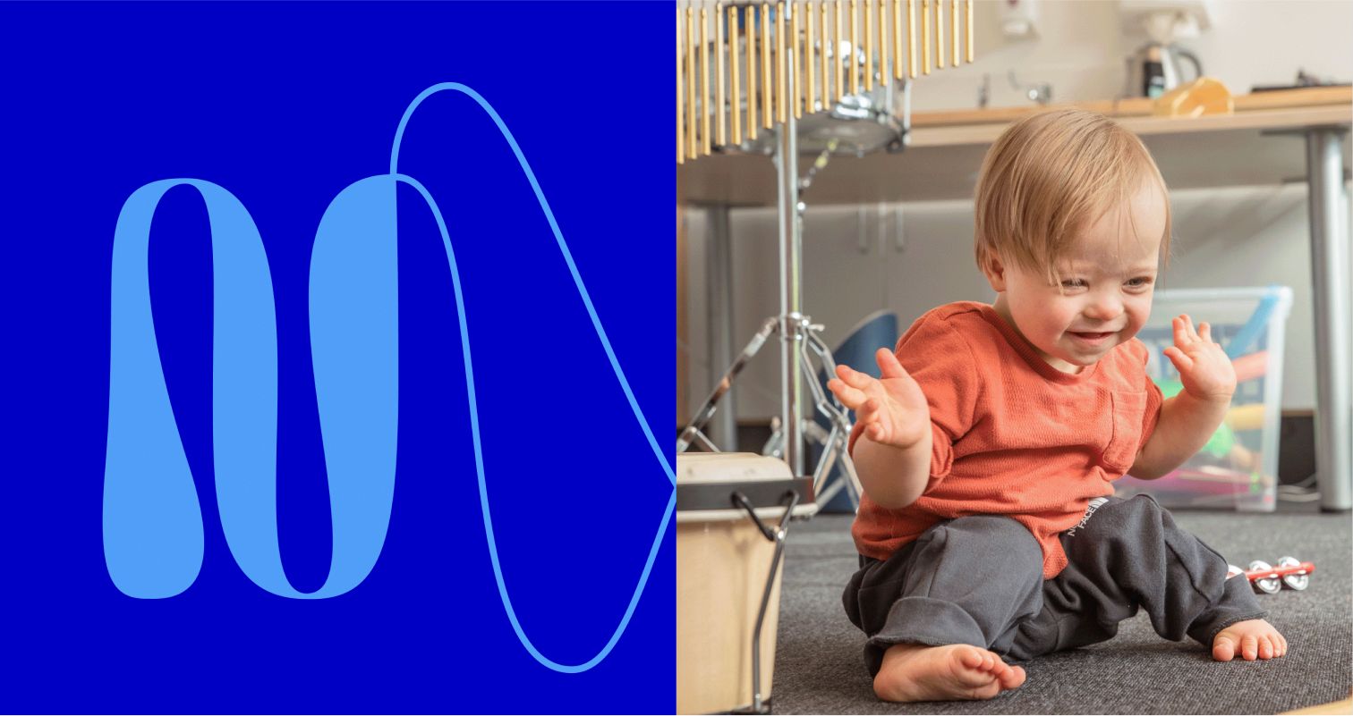 Nordoff and Robbins brand mark, a flowing blue line, beside a young child clapping during a music therapy session