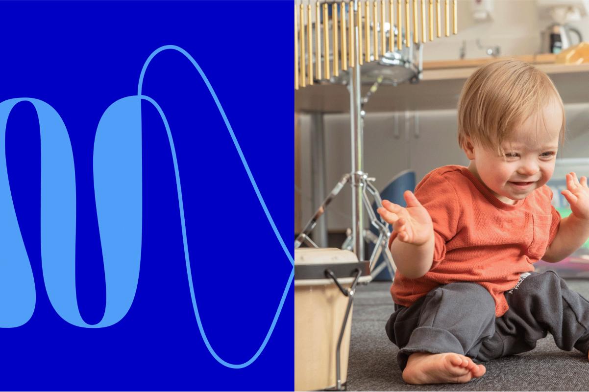 Nordoff and Robbins brand mark, a flowing blue line, beside a young child clapping during a music therapy session